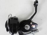 a close up of a fishing reel on a white surface