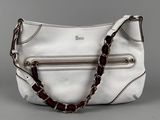 a white purse with a chain around the strap