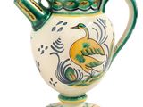 a green and white vase with a bird on it