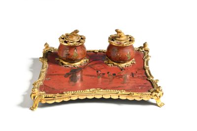 a red and gold tray with two jars on it