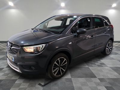a grey car is parked in a room with a checkered floor