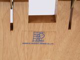 a close up of a wooden chair with a logo on it