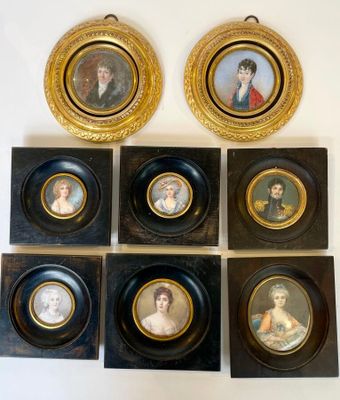 six framed portraits of people are displayed on a wall