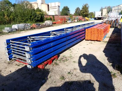 a man that is standing next to a pile of pipes