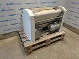 the machine is sitting on a pallet in front of a wall