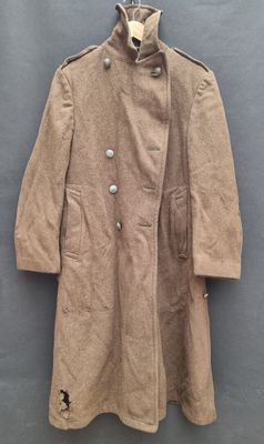an old coat hanging on a wall with a blue background