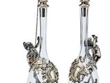 pair of silver and glass vases with birds on them