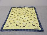 yellow and blue dog blanket with black and white checkered border