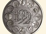 a silver coin with a picture of a number of people on it