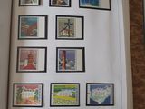 a book with stamps on the pages and a picture of a lighthouse