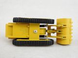 a close up of a yellow robot toy on a white surface