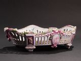 an image of a pink and white basket with flowers on it