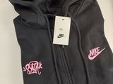 a black hoodie with a pink nike logo on it