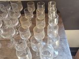 a lot of empty glasses sitting on a wooden table