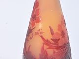 a glass vase with a red and yellow design on it
