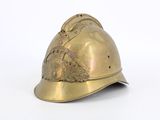 a gold helmet that is sitting on a white surface