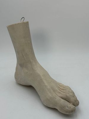 a sculpture of a foot that is on a table