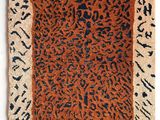 a brown and black rug with a leopard print on it