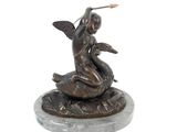statue of a woman sitting on a turtle with a sword in her hand