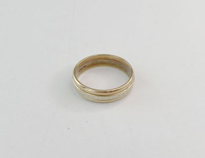gros plan d'une bague en or sur une surface blanche