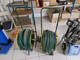 two hoses and a cart on the floor in a garage