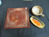 two bowls and a tray on a table with a black table cloth