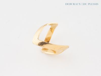 the gold ring has a curved design on it ' s side