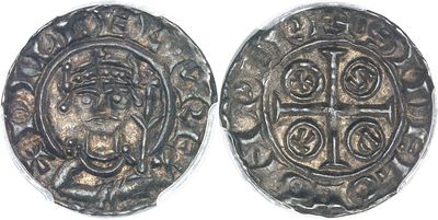 a silver coin with a cross on the front and a cross on the back