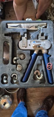 many tools in a tool box on the floor