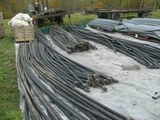 a large pile of steel pipes sitting on the ground