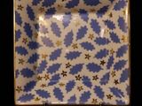 a picture of a blue and white plate on a black surface