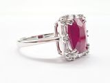 an oval ruby and diamond ring with a baguet setting