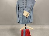 a blue jacket and red pants on a mannequin stand