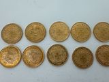 a bunch of gold coins sitting on top of a white surface