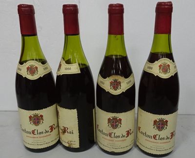 four bottles of wine are lined up on a table
