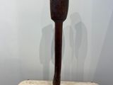 sculpture of an owl made of wood on a marble base
