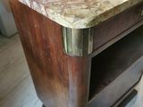 a wooden table with a marble top on a hard wood floor