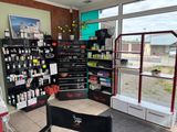 an image of a salon with a lot of products on the shelves