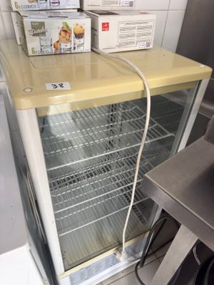 a refrigerator that has two boxes on top of it