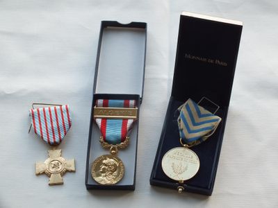 two medals and a medal in a box on a table