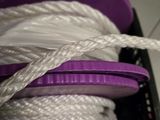 a white rope with a purple plastic spool on it