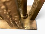 a close up of a metal object on a white surface