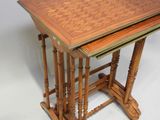 a pair of wooden nesting tables on a white background