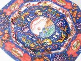a blue plate with a picture of a woman on it