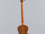 an image of a guitar hanging from a string on a gray background