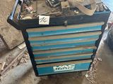 a blue tool box with tools on top of it in a garage