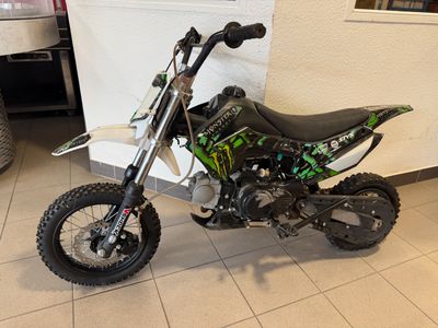 a dirt bike that is sitting on the floor