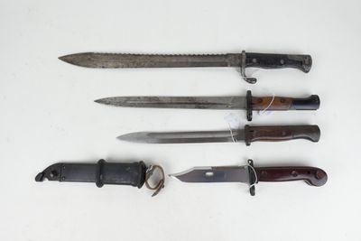 four different types of knives are lined up on a white surface