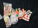 a lot of dolls in plastic bags on a black surface