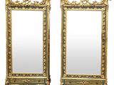 pair of antique mirrors with gold and green paint on the sides